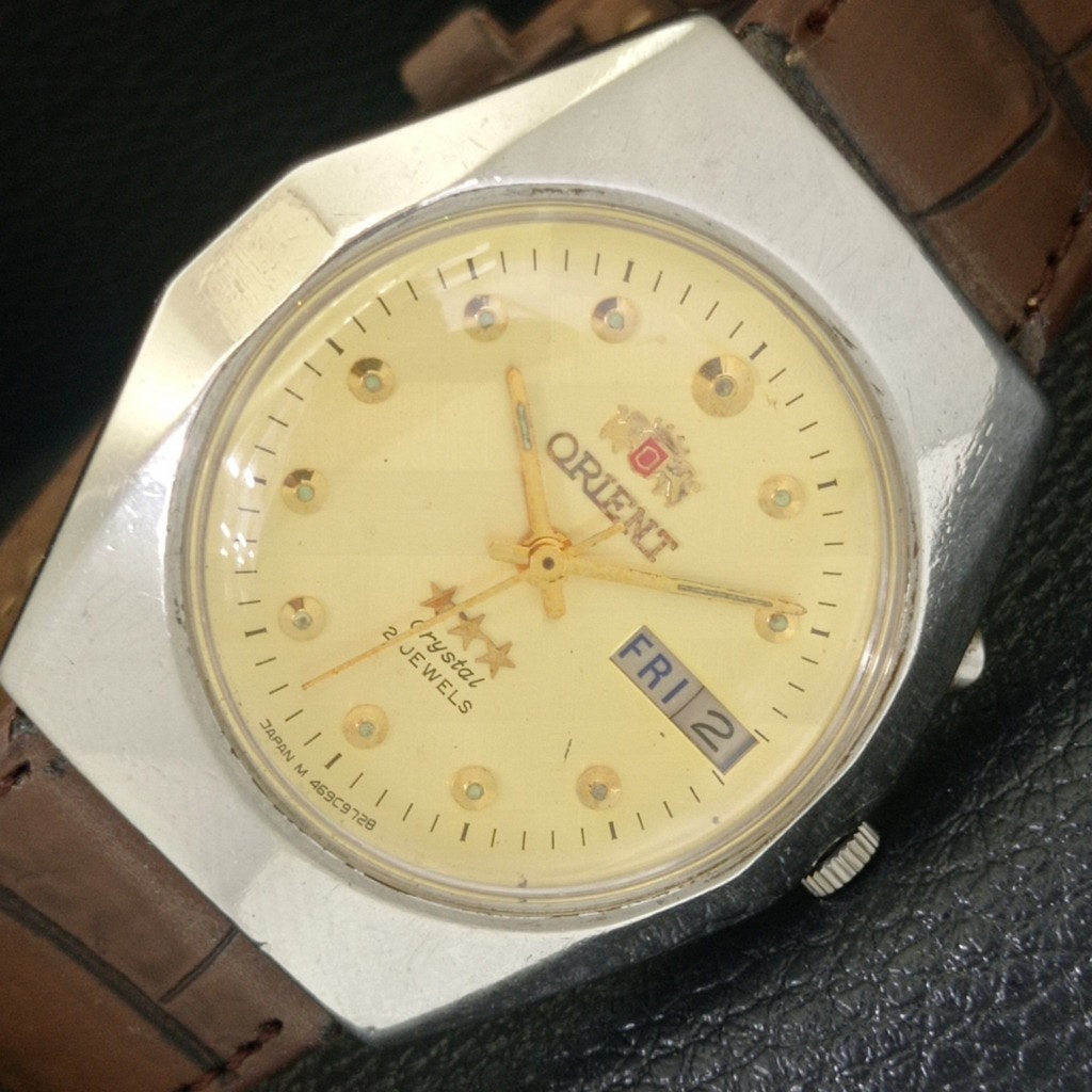Vintage 1976 Orient Automatic Mens Silver Watch WDaydate Gold Accents Vintage 1976 Orient Automatic Mens Silver Watch WDaydate Gold Accents